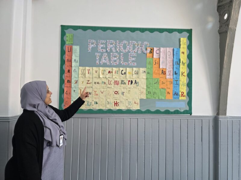Miss Shamim Akhtar, Academic Leader, at the periodic table